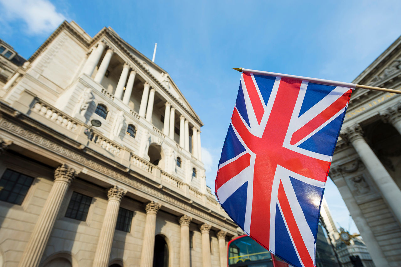 British Union Jack flag flying in front of the Bank of England in the City of London financial center