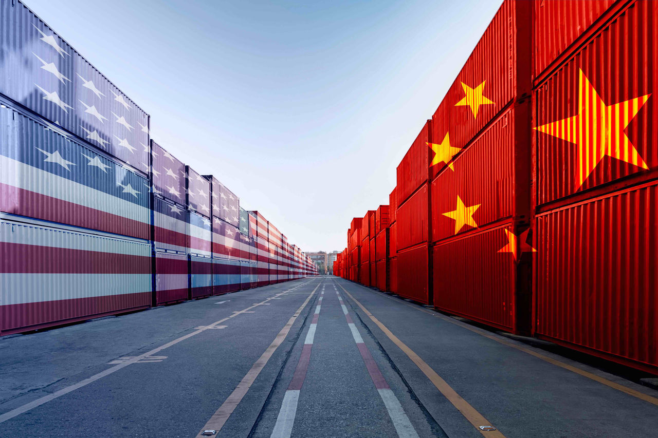 Metaphor image of United States of America and China trade war tariffs as two opposing container cargo in the port as an economic taxation dispute over import and exports concept 